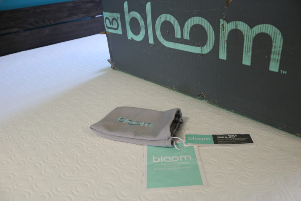 The Bloom mattress, the box it was delivered in, and the in-box extras