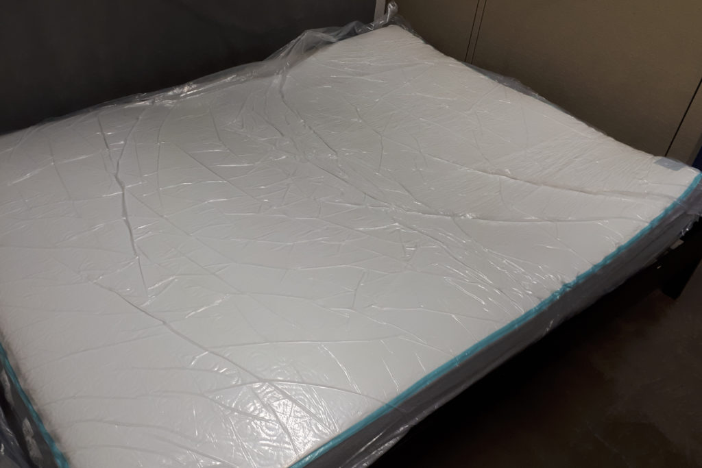 The Bloom mattress wrapped in plastic and expanding