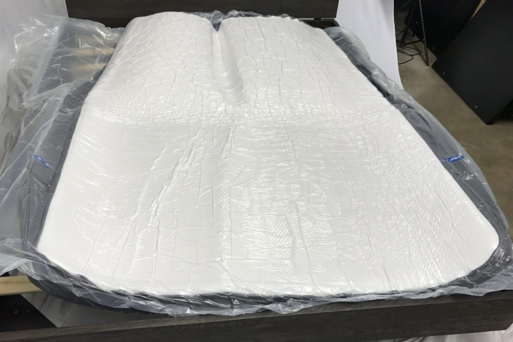 The Caspar mattress wrapped in plastic and expanding