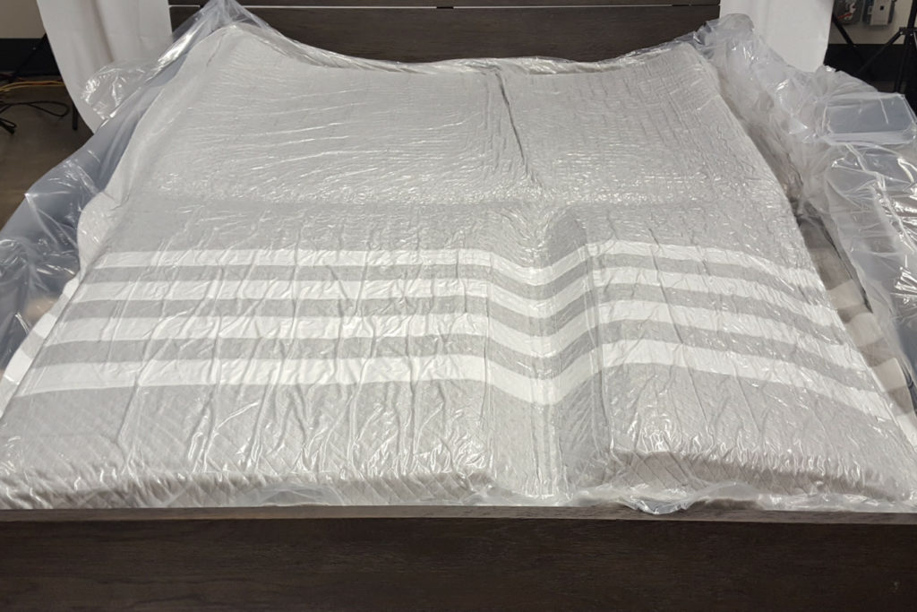 The Leesa mattress wrapped in platic and expanding