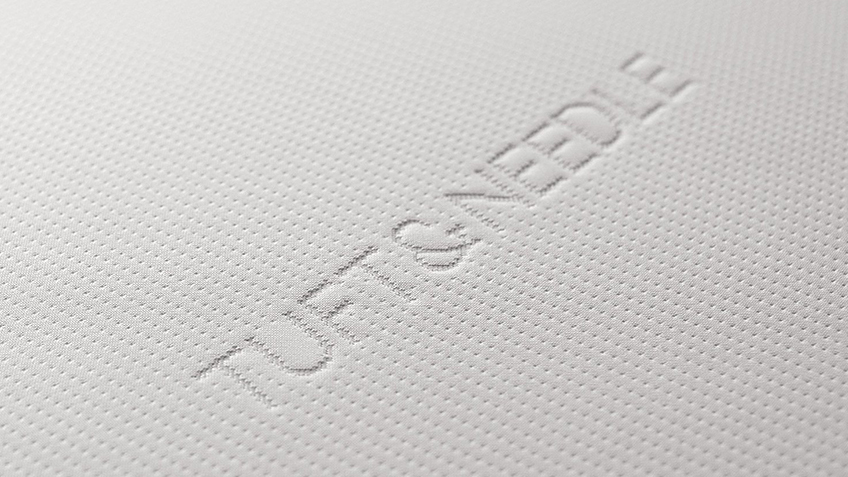 Image of the Tuft & Needle mattress logo on the top cover of the Tuft & Needle mattress.