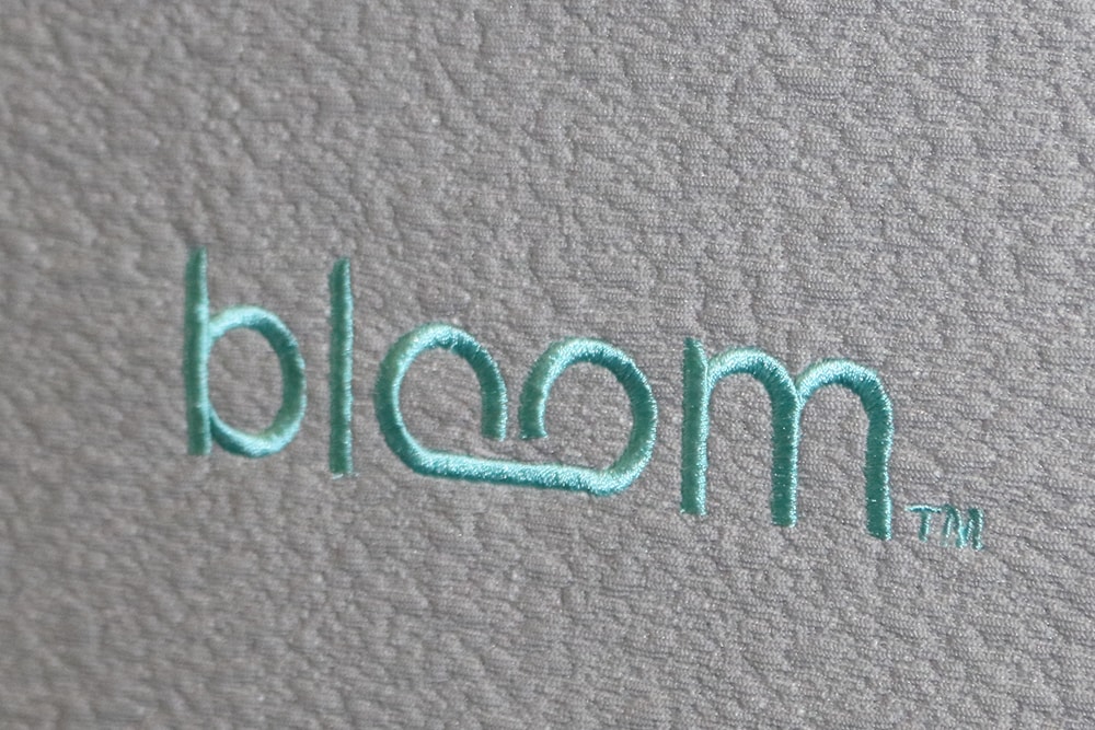 Image of the Bloom logo on the front cover of the Bloom mattress on by Sleep Country.
