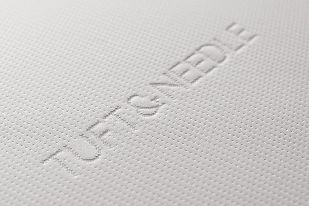 Image of the Tuft & Needle mattress logo on the top cover of the Tuft & Needle mattress.