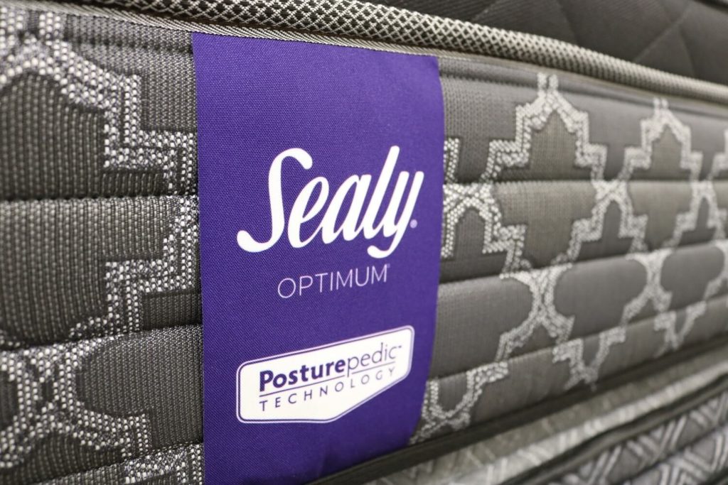 Image of the Sealy Posturepedic mattress tag on the front cover.