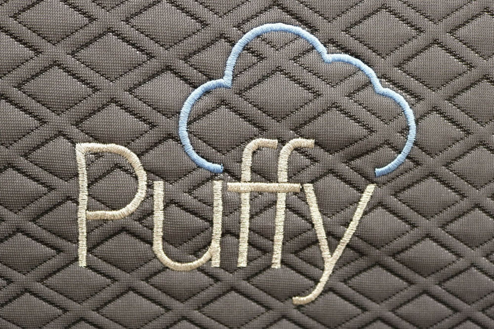 Image of the Puffy mattress tag on the front cover.