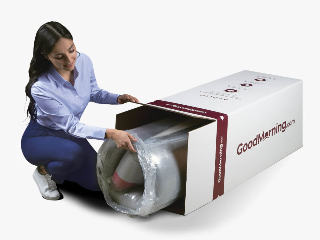 Woman unboxing the rolled up and compressed Apollo mattress