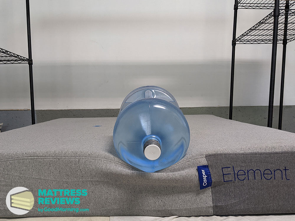 Casper Element mattress with water jug sitting on side to test edge support