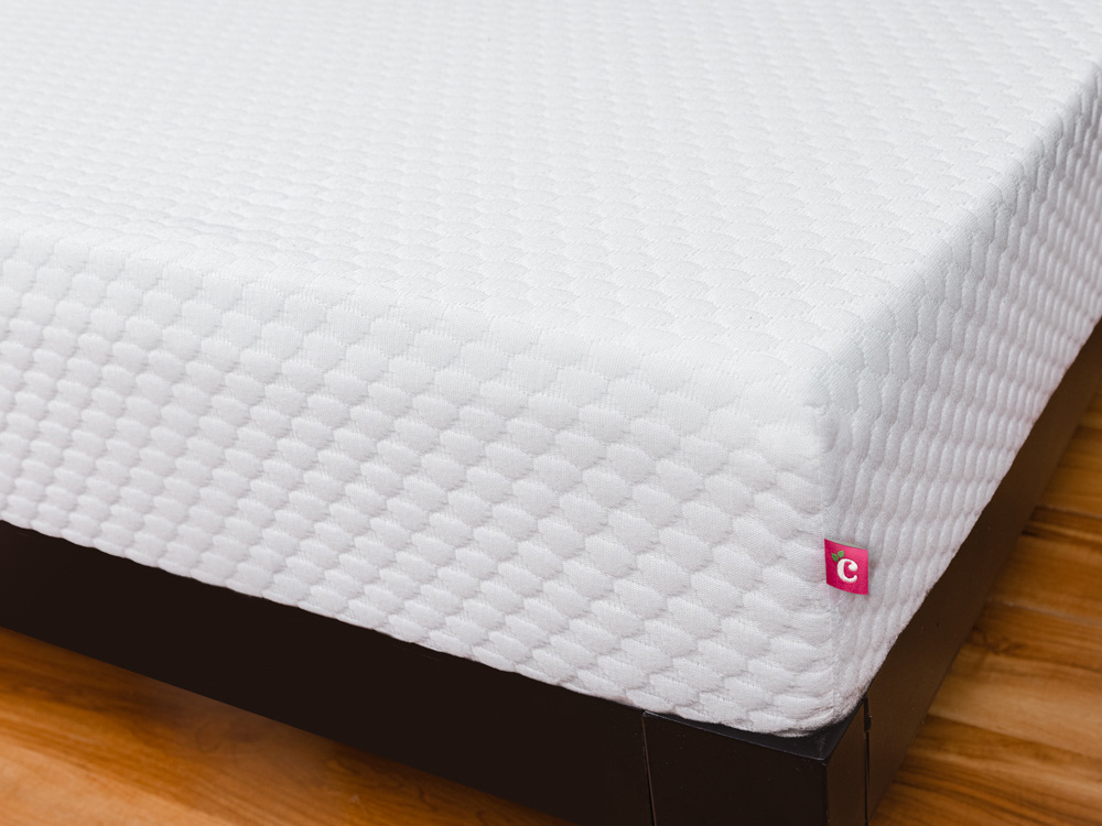 Front corner of Cherry mattress, place on a black platform bed