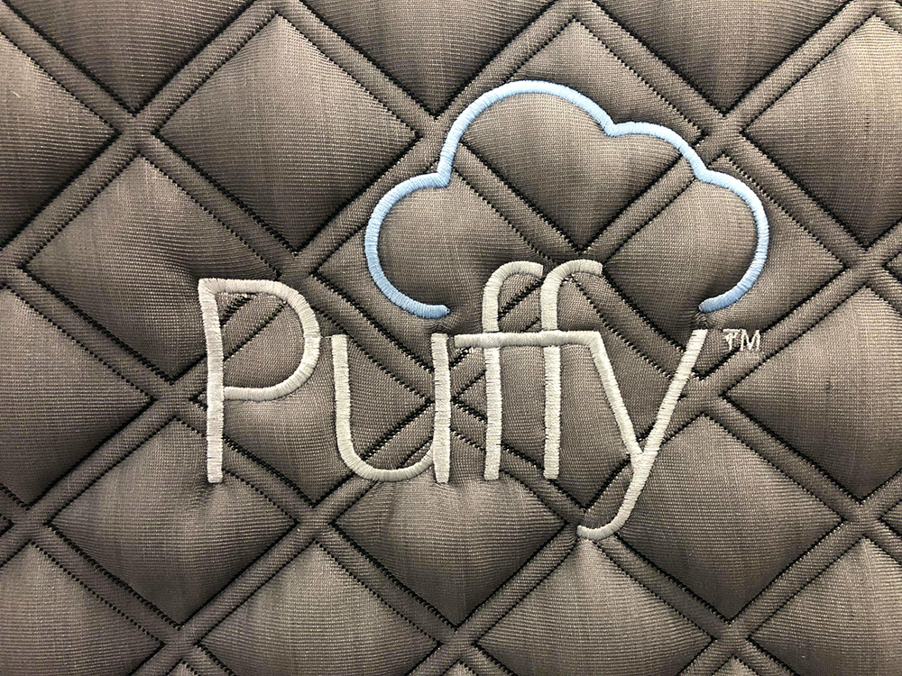 Image of the Puffy Lux Company Logo on the side of the mattress.