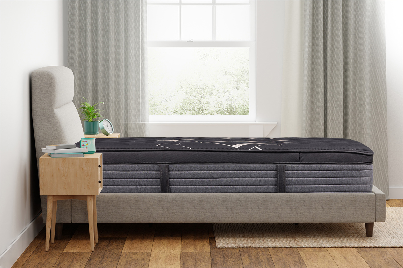 Side angle view of a Beautyrest Black mattress on a bed