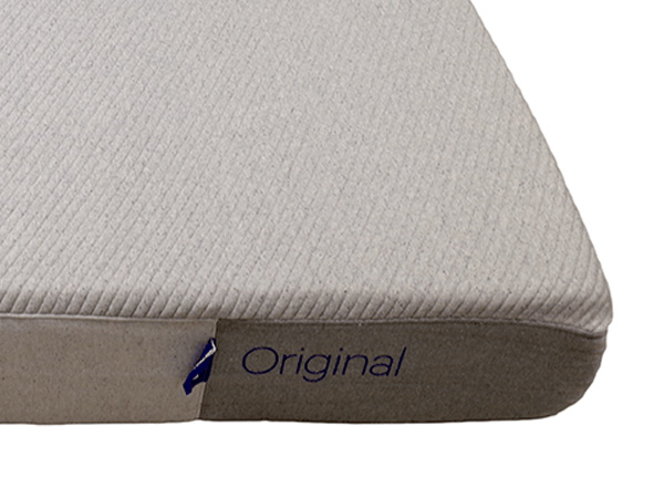 The front right corner of the Casper Original mattress showing brand logo and blue tag