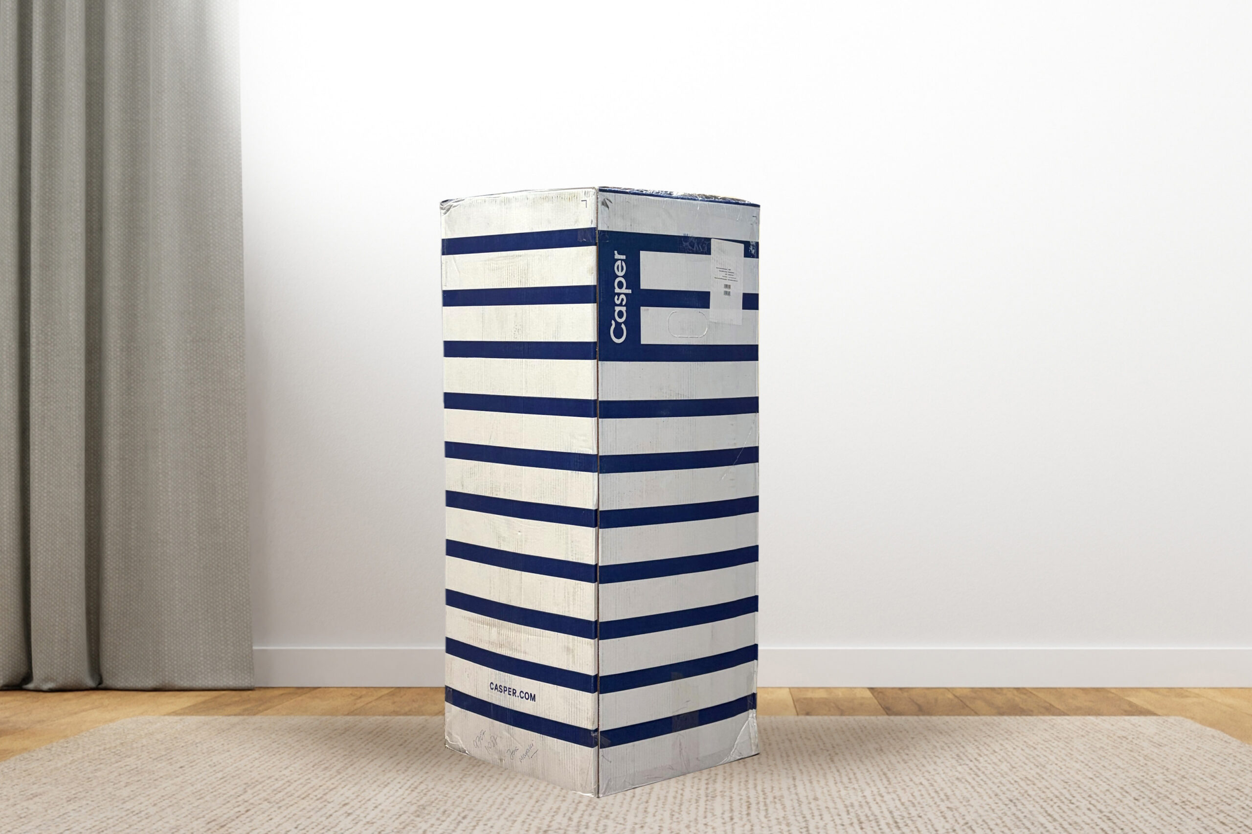 CasperSnowBox MattressReviewscom Casper Snow mattress delivery box on a carpet in a room