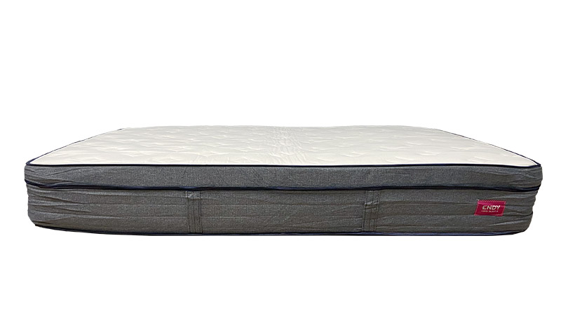 Image of the Endy Hybrid mattress from the side against a white background