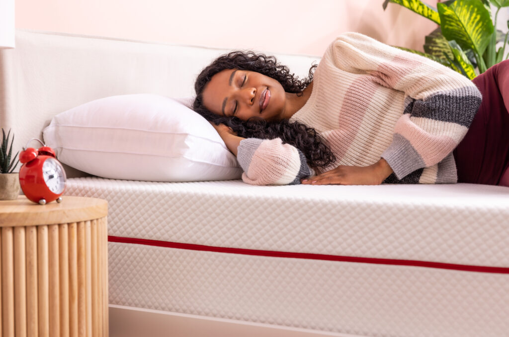 Photo of a young woman sleeping on the Douglas Alpine mattress.