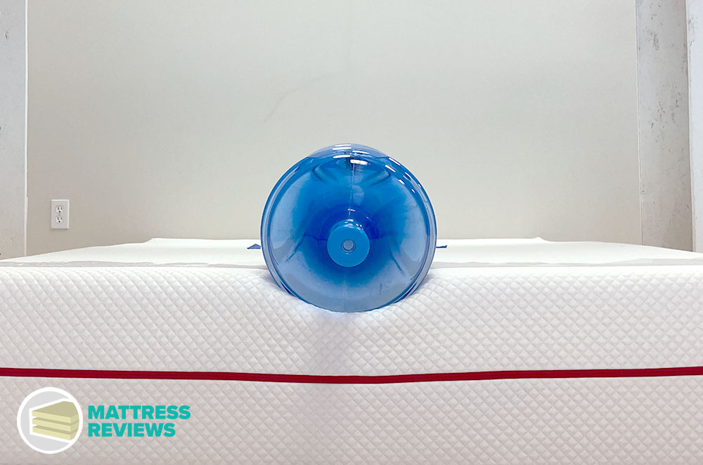 A heavy jug of water rests along the edge of the Douglas Summit mattress with minimal sinkage