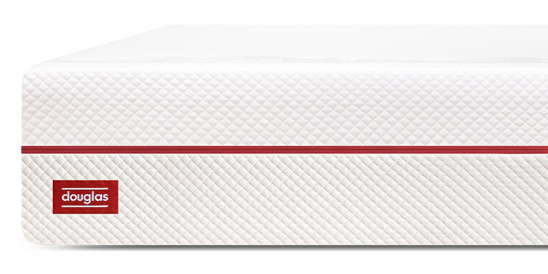 The front corner of the white and red Douglas Summit mattress