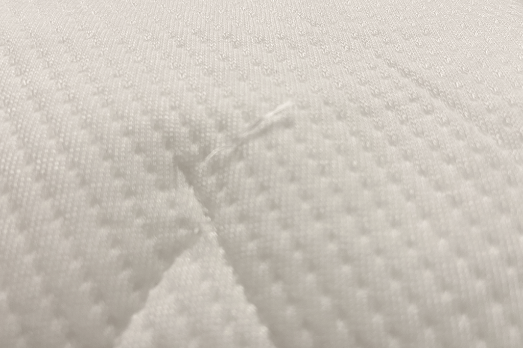 Close-up image of the white quilted fabric on the Endy Hybrid mattress