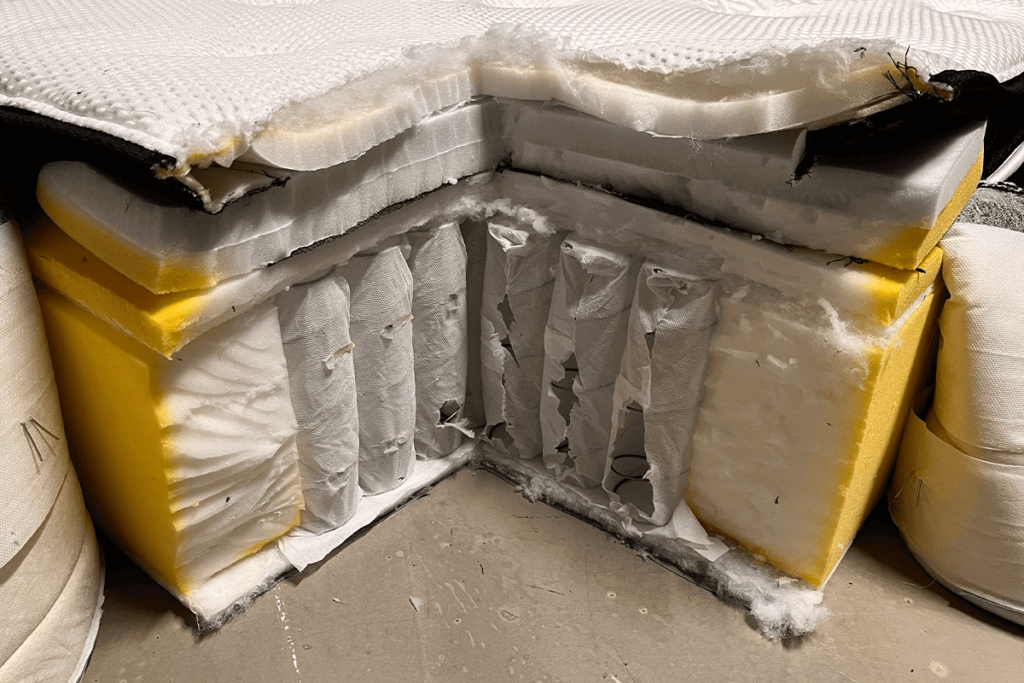 Image of the inside of a Hush hybrid mattress with pocketed coils, yellow oxidized foam, and fibre batting.