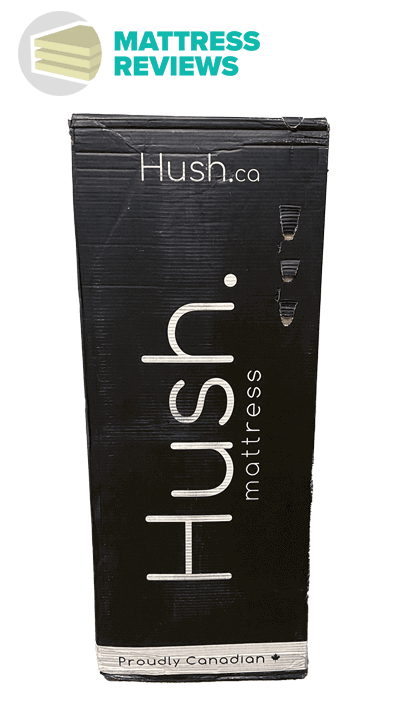 The black Hush mattress box with a few minor punctures and Mattress Reviews logo