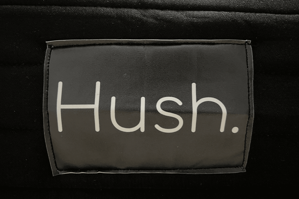 Image of the Hush mattress logo on a the front of a Hush Hybrid mattress