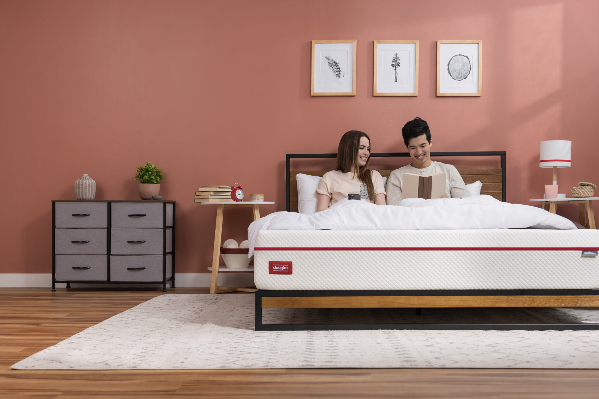 Image of two people on a Douglas mattress in a spacious bedroom