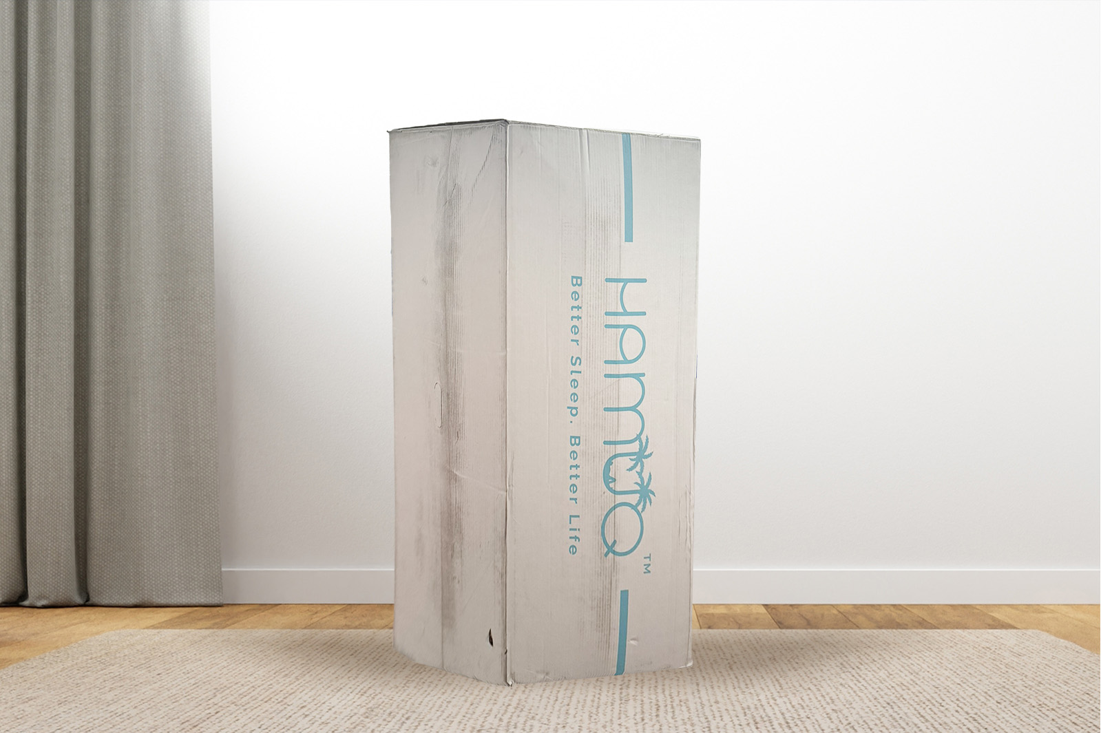 Photo of an Original Hamuq mattress delivery box sitting on a carpet in a room