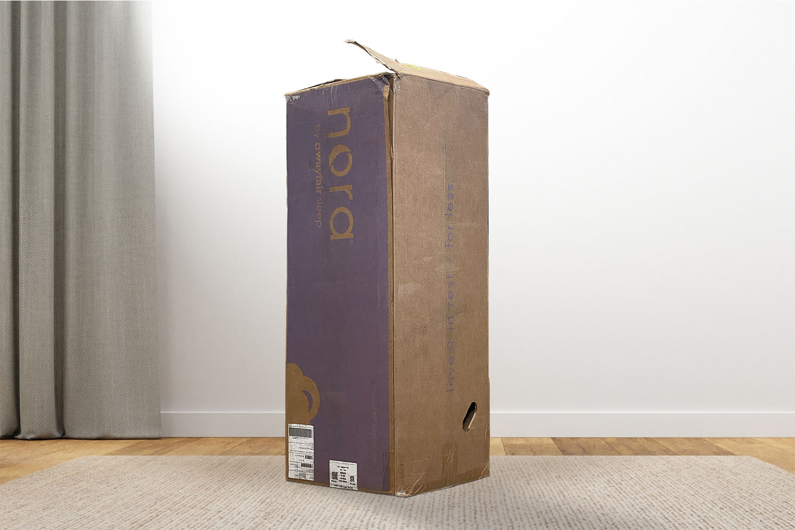 NoraBox MattressReviewscom The nora mattress box standing upright on a carpet in a bedroom