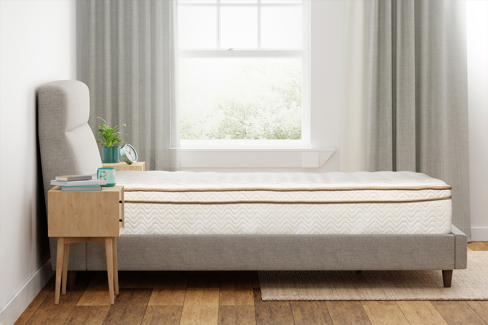 SaatvaClassicSideAngle MattressReviewscom Side view of a Saatva Classic mattress on a bedframe in a bedroom