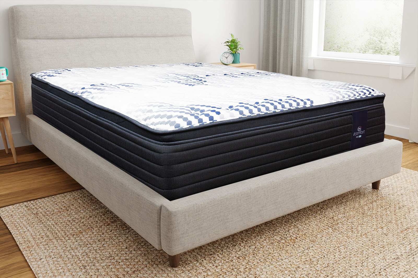 Corner view of the Serta iComfort Hybrid mattress on a bed