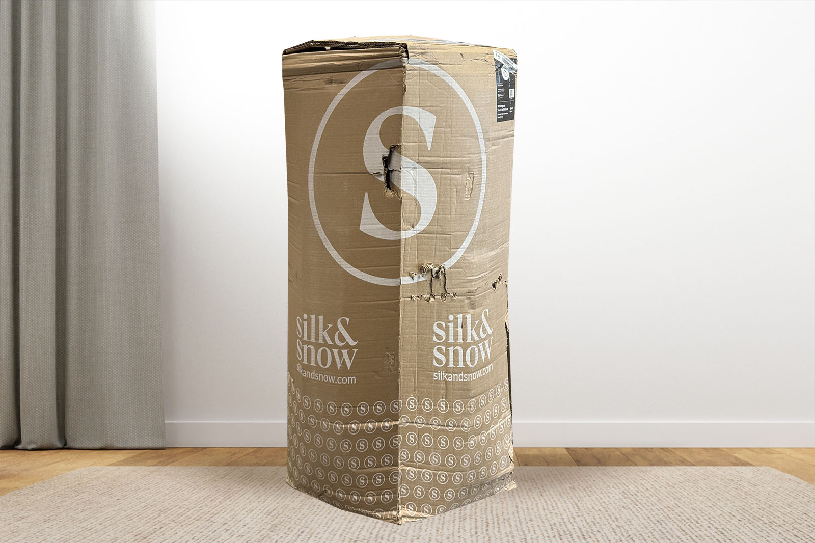 Photo of a SS Organic mattress delivery box sitting on a carpet in a room