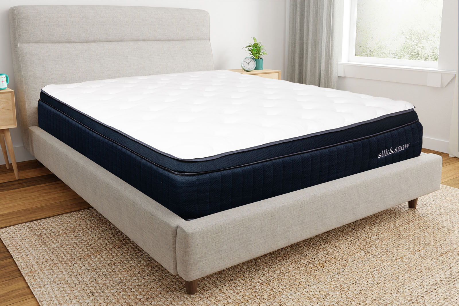 Corner view of the silk snow mattress on a bed
